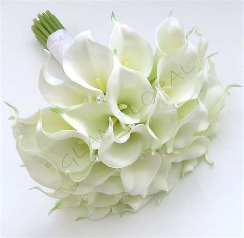 A Bridal Bouquet With White Flowers And Greenery