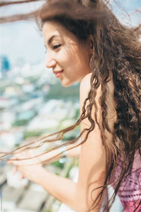 Young Beautiful Woman Looks At The City From The Rooftop By Stocksy Contributor Michela