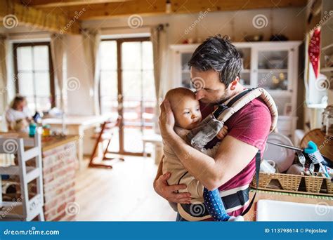 Father With A Baby Girl In A Carrier At Home Stock Photo Image Of