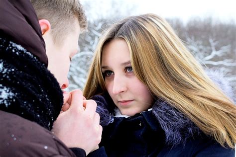 The Guy Gently Warms His Hands With The Young Girl Lovingly Looks Into Her Eyes She Sincerely
