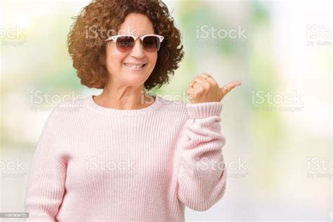 Beautiful Middle Ager Senior Woman Wearing Pink Sweater And Sunglasses
