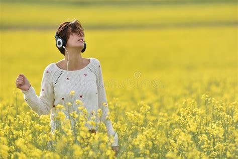Young Woman Enjoying Music In The Headphones In The Outdoors Stock
