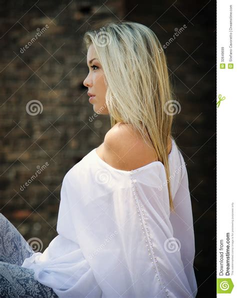 Profile Of Pretty Blonde Girl Sitting Outdoors Royalty