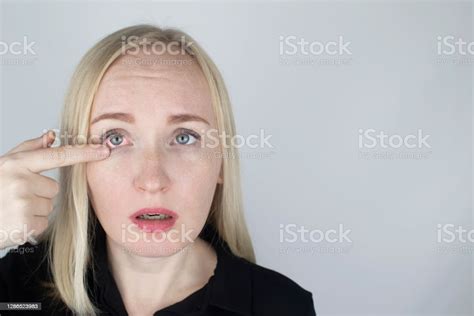 A Woman Rubs His Tired Eyes With His Hands On A White Background Eye