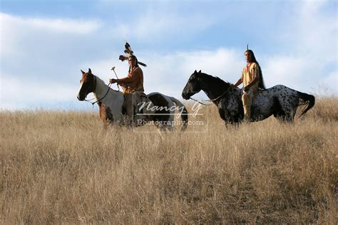 Two Native American Indian Men Riding Bareback On Horses In Traditional