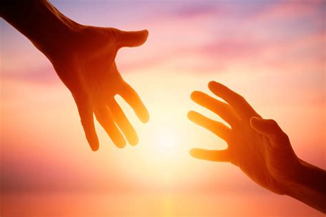 Giving A Helping Hand On The Background Of The Dawn Stock Photo