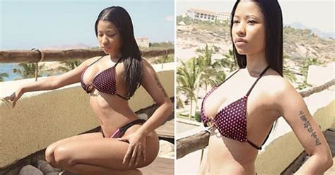 At Least She S Dressed This Time Nicki Minaj Bares Mega Cleavage In Bikini Daily Star