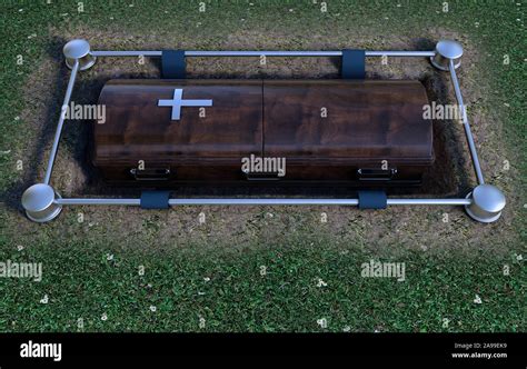 A Modern Wooden Coffin At A Funeral Being Lowered Into A Grave With A