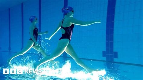 Synchronised Swimmers Dance In The Water