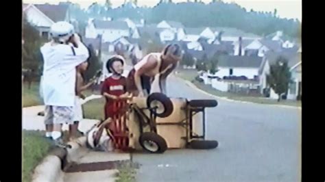 Helmeted Kids In Red Wagon Crash Into Sidewalk And Go Flying