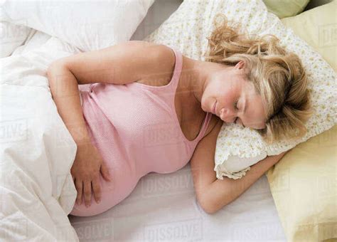 Pregnant Woman Asleep In Bed Stock Photo Dissolve