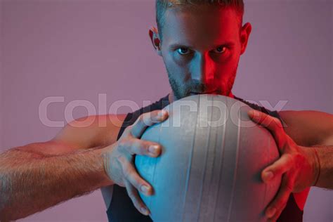 Handsome Concentrated Young Sports Man Holding Ball Stock Image