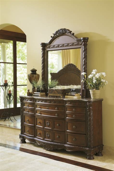Made of veneers, wood, manmade wood and cast resin includes headboard, footboard and rails North Shore Bedroom B553-S Dark Brown by Ashley Furniture