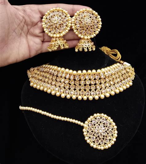 traditional gold plated kundan with white pearls choker necklace maang tikka and earrings for