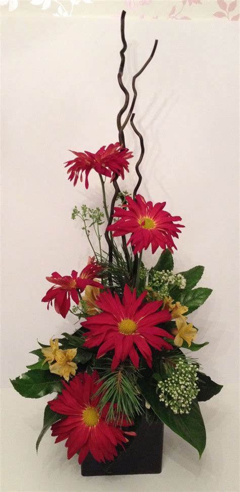 Twigs, posts and other materials are used to provide a vertical and horizontal structure to the silk floral arrangement or centerpiece. Large contemporary vertical flower arrangement / design ...