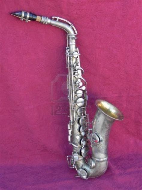 An Antique Silver Plated Alto Saxophone Leaning On A Red Felt