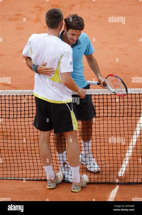 switzerland s roger federer embraces sweden s robin soderling after their men s singles final