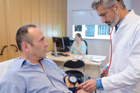 Doctor Taking Patient S Blood Pressure Stock Photo Image Of