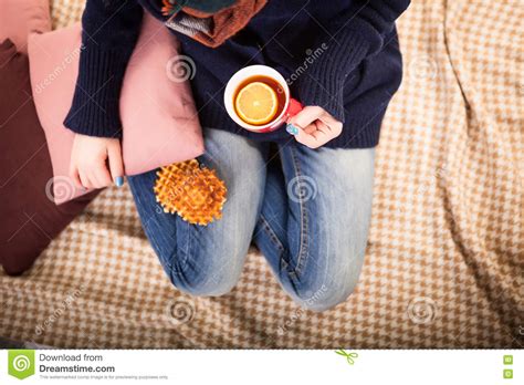 Woman Holds Hot Cup Of Tea Or Coffee Warming Her Hands Stock Photo