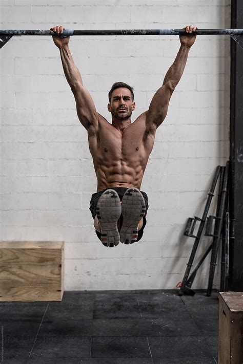 Athlete Hanging On Horizontal Bar Doing Pull Ups By Stocksy