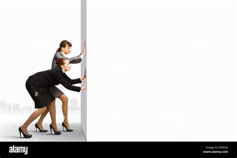 Two Businesswoman Pushing Blank White Banner Place For Text Stock