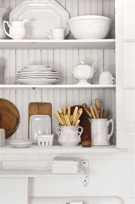 This Cream Colored Over The Sink Cupboard Displays White Serving Ware