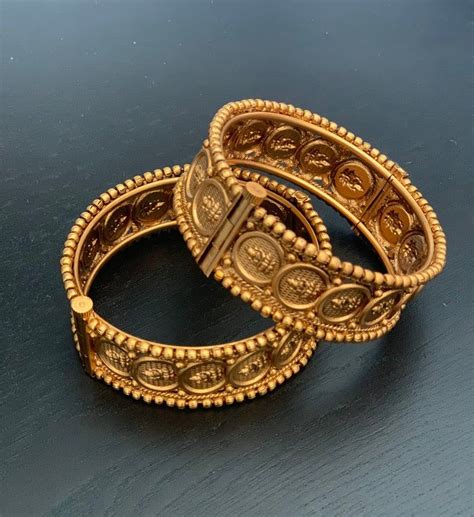 A Pair Of Antique Gold Plated Lakshmi Devi Kada In Size 24 Bracelets