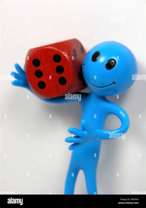 Blue Bendy Toy Man With Red Dice Stock Photo Alamy