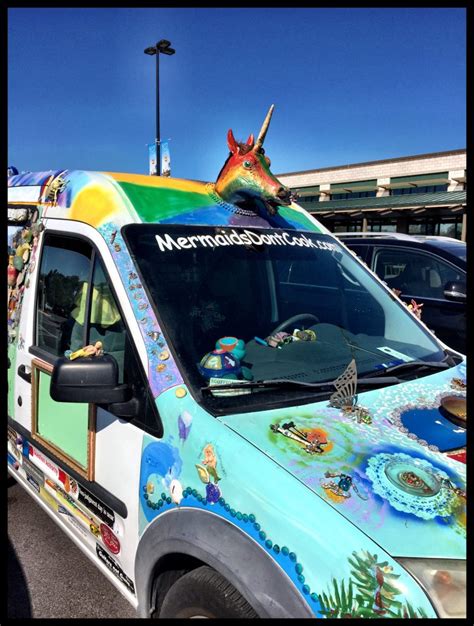 An Elaborately Decorated Art Car With A Unicorn Head And Horn Leading