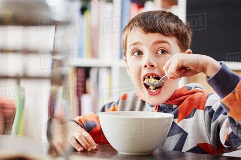 Young Boy Eating Breakfast Stock Photo Dissolve