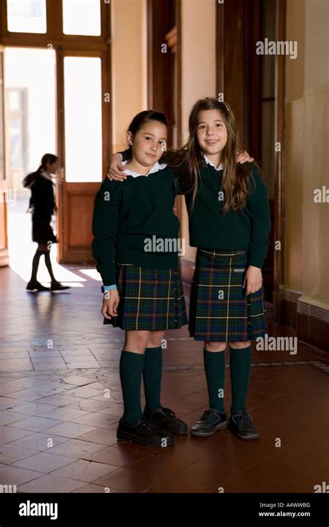 Female Students Hugging In School Hallway Stock Photo Alamy