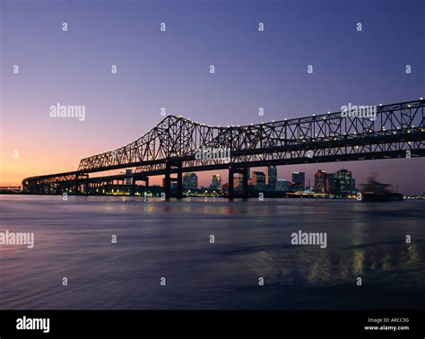 Mississippi River Bridge In The Evening And City Beyond New Orleans