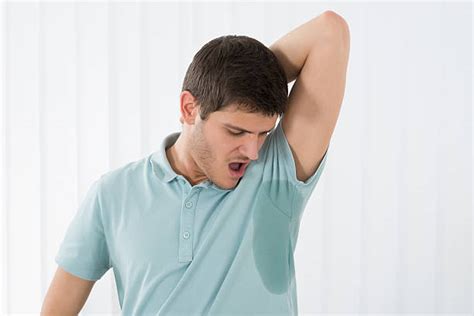 140 Young Man Sniffing His Underarm Because Of His Armpit Smell Stock