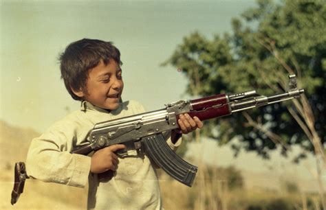 An Afghan Kid Playing With An Ak 47 1989 Rafghan