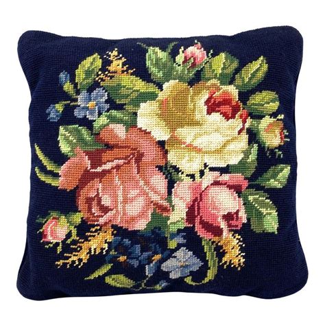 a lovely mid century needlepoint decorative pillow with pink and white roses and other floral