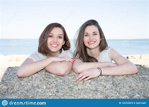 Lesbian Couple Standing At The Beach In Love Looking Into Camera Stock Image Image Of Happy