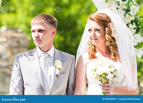 Couple Getting Married At An Outdoor Wedding Ceremony Stock Photo
