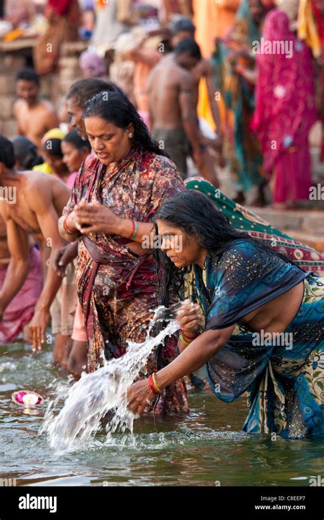 Indian Hindu Pilgrim Bathing And Praying In The Ganges River At Dashashwamedh Ghat In Holy City