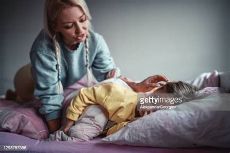 A Mother Waking Up Next To Her Sleeping Child Photos And Premium High