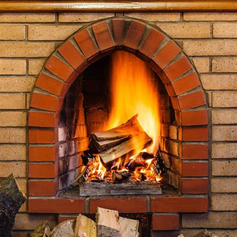 wood burning in indoor brick fireplace stock image everypixel