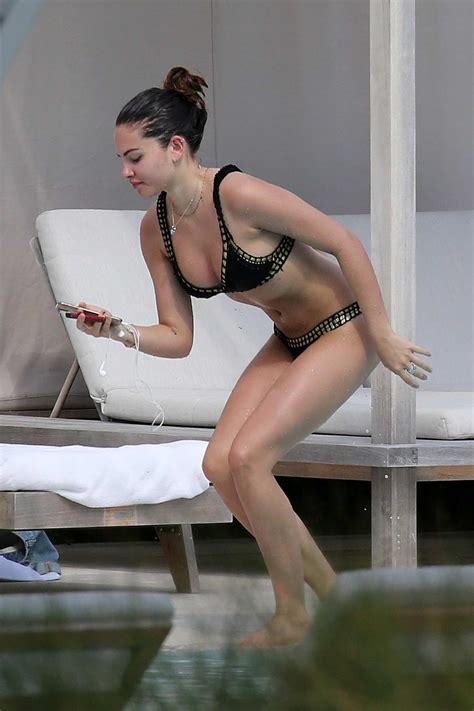 Thylane Blondeau Seen Relaxing By Hotel Pool Wearing A Black Bikini And Using A Vaping Pen In
