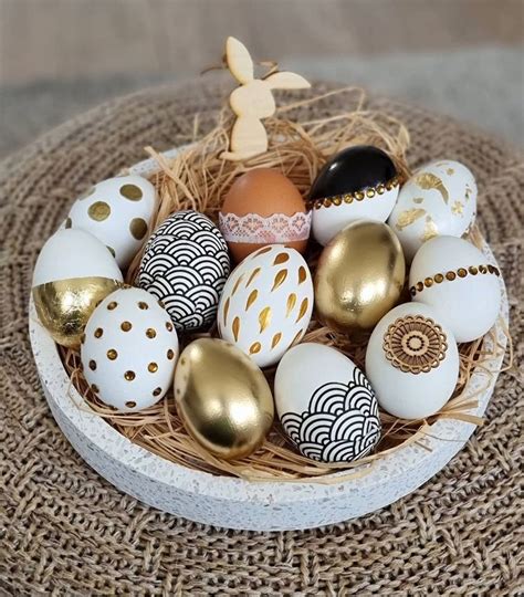 An Arrangement Of Painted Eggs In A Basket On Top Of Burlocked Cloth