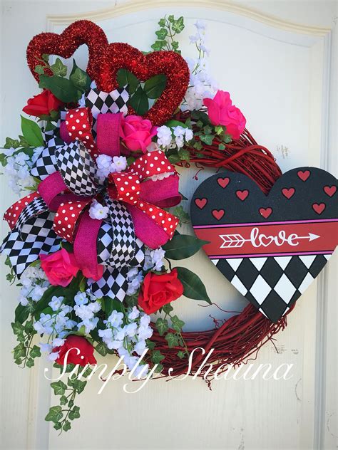 A Valentines Wreath With Hearts And Flowers On The Front Door Is