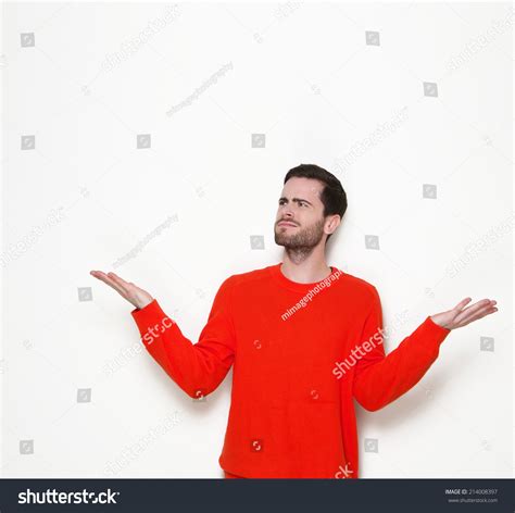 Portrait Of A Young Man Asking Questions With Hands Raised Stock Photo