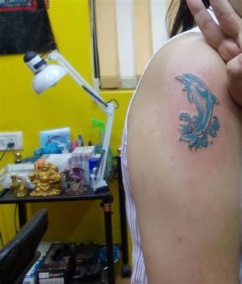 adorable dolphin tattoo on shoulder