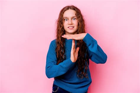 Premium Photo Little Girl Isolated On Pink Wall Showing A Timeout Gesture