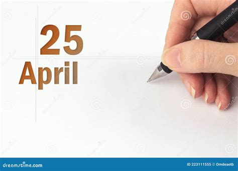 April 25th Day 25 Of Month Calendar Date The Hand Holds A Black Pen
