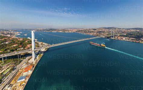 Aerial View Of A Shipping Boat Crossing Under Bosphorus Bridge