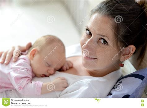 Close Up Of Mother Holding Her Cute Baby Daughter Stock