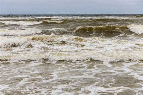 Dirty Sea Waves Hitting The Beach In Stormy Weather Stock Photo